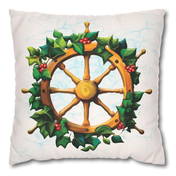 Decorative pillow with a ship's wheel and holly design on a white background