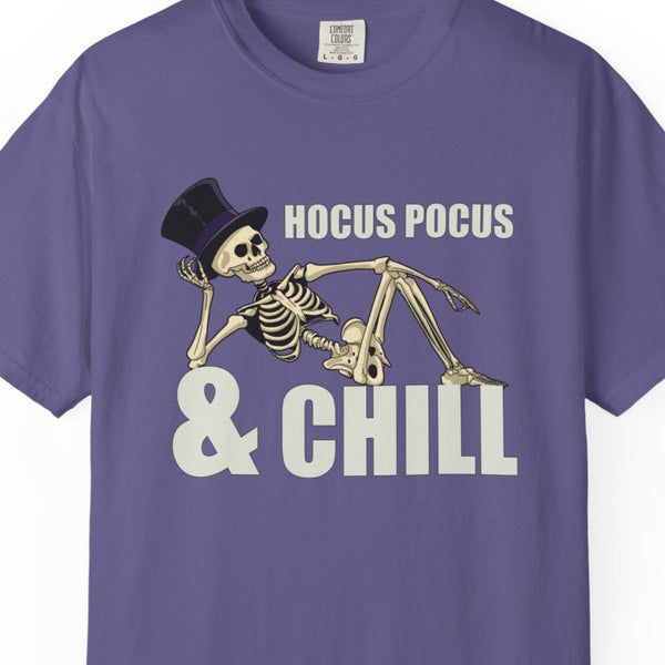 Purple t-shirt with skeleton design and 'HOCUS POCUS & CHILL' text on a white background