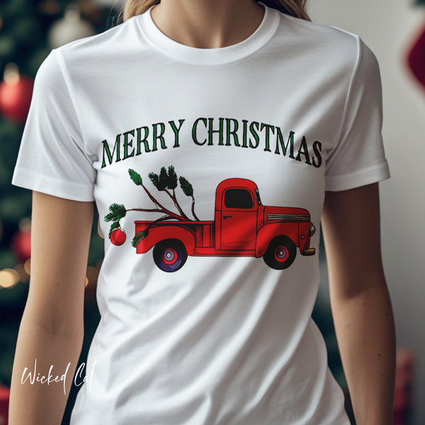 White t-shirt with a red truck and 'Merry Christmas' design, worn by a person.