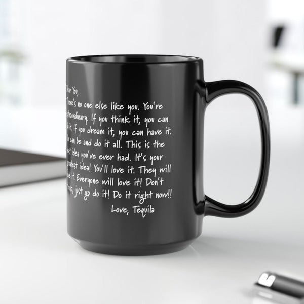 Black mug with text on a white surface with blurred background. Funny office mug.