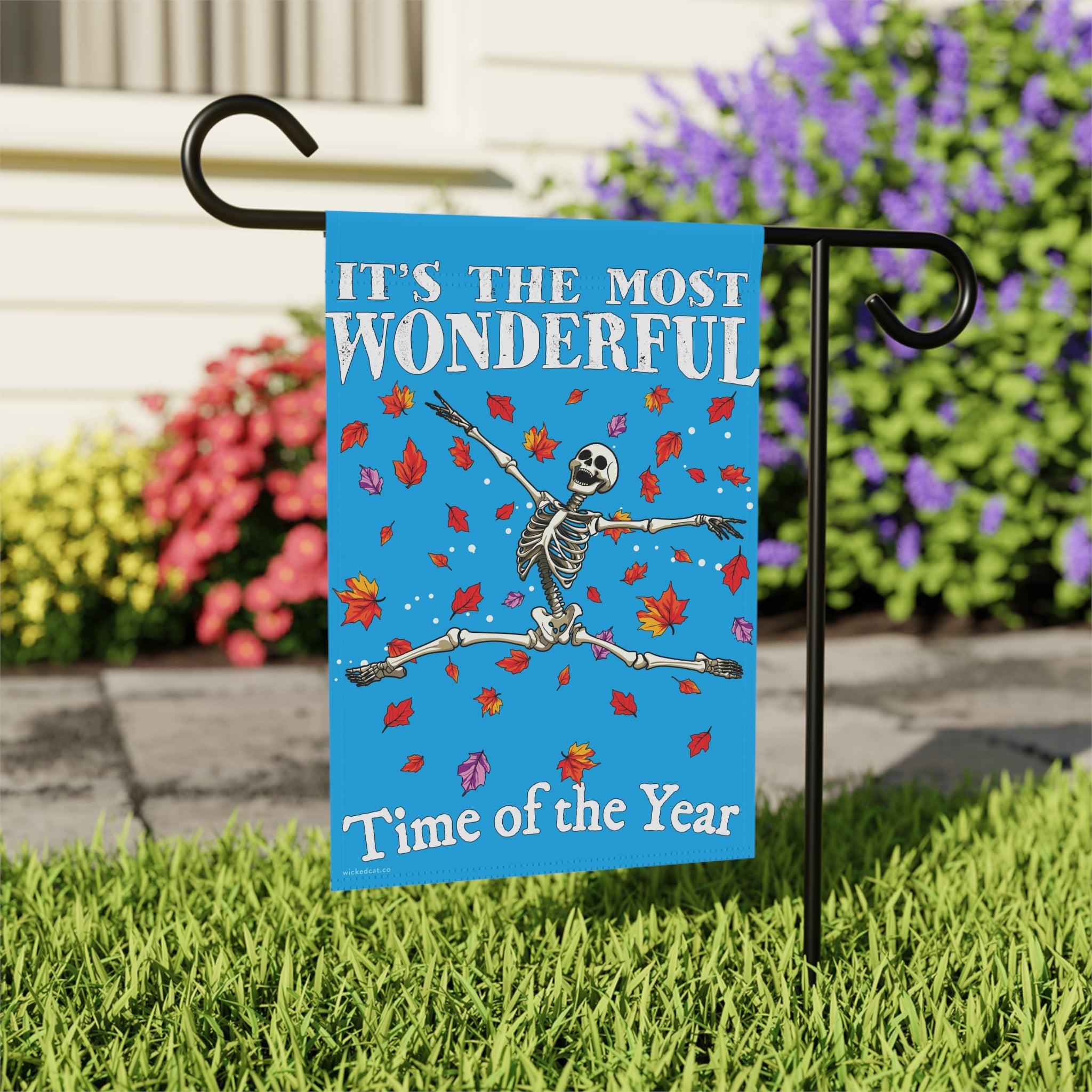 Decorative flag with skeleton and text 'It's the most wonderful time of the year' on a blue background.