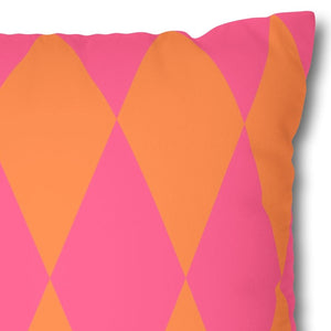 Decorative pillow with pink and orange diamond pattern on a white background
