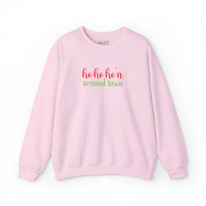 Pink sweatshirt that reads ho ho ho'n around town in red and green text.