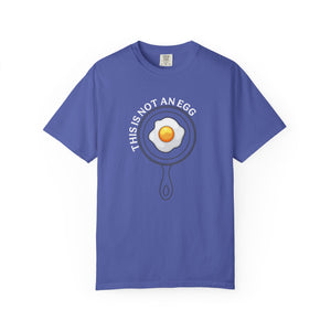 Purple t-shirt with an egg in a pan graphic and text on a white background