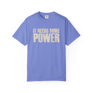Purple t-shirt with 'IT NEEDS MORE POWER' text on a white background