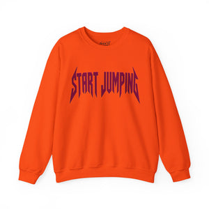 Bright orange crewneck sweatshirt with a stylized dark purple 'START JUMPING' graphic printed across the chest, displayed on a clean white background.