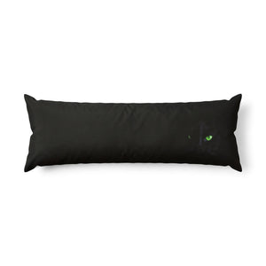 A full body pillow in black with a hand-illustrated black cat with piercing green eyes.