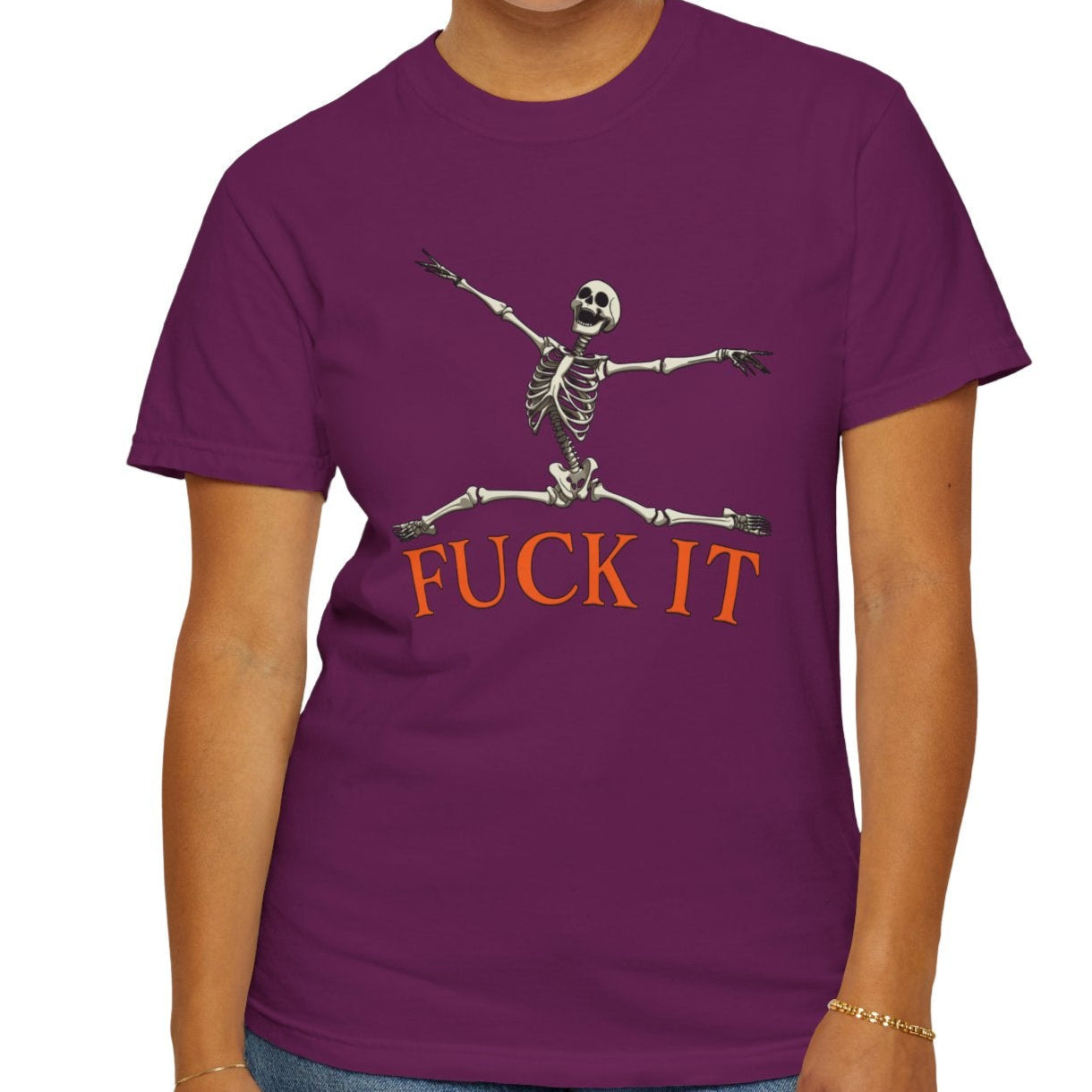 Person wearing a purple t-shirt with a skeleton design and text on a white background