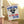 Funny July 4th garden flag banner with ninjas and text Kicking Kings to the Curb since 1776 on an off white background, hanging from pillar