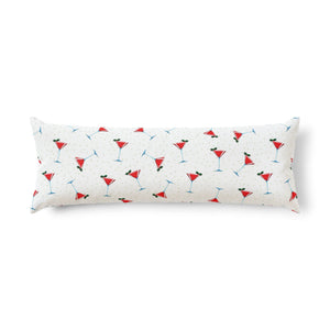 A long rectangular lumbar pillow with a white background and a repeating pattern of red martini glasses with blue stems and green olives, set against a plain white background.