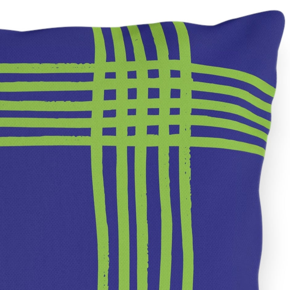 Blue purple pillow with green plaid pattern on a white background