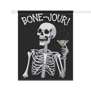 Yard flag and banner with a skeleton holding a martini that says Bone-jour at the top on a black background.