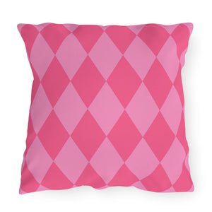 Pink diamond patterned pillow on a white background