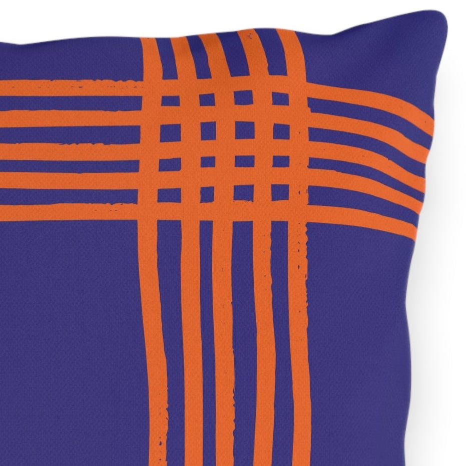 Plaid-patterned pillow with blue and orange lines on a white background