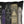 A square black throw pillow featuring a printed graphic of six gothic-style book spines, including titles such as The Glass Cauldron, The Graveyard Diaries, Venom, Cloaks, and Astronomica, Book of Shadows, Inception, and The Spirit.