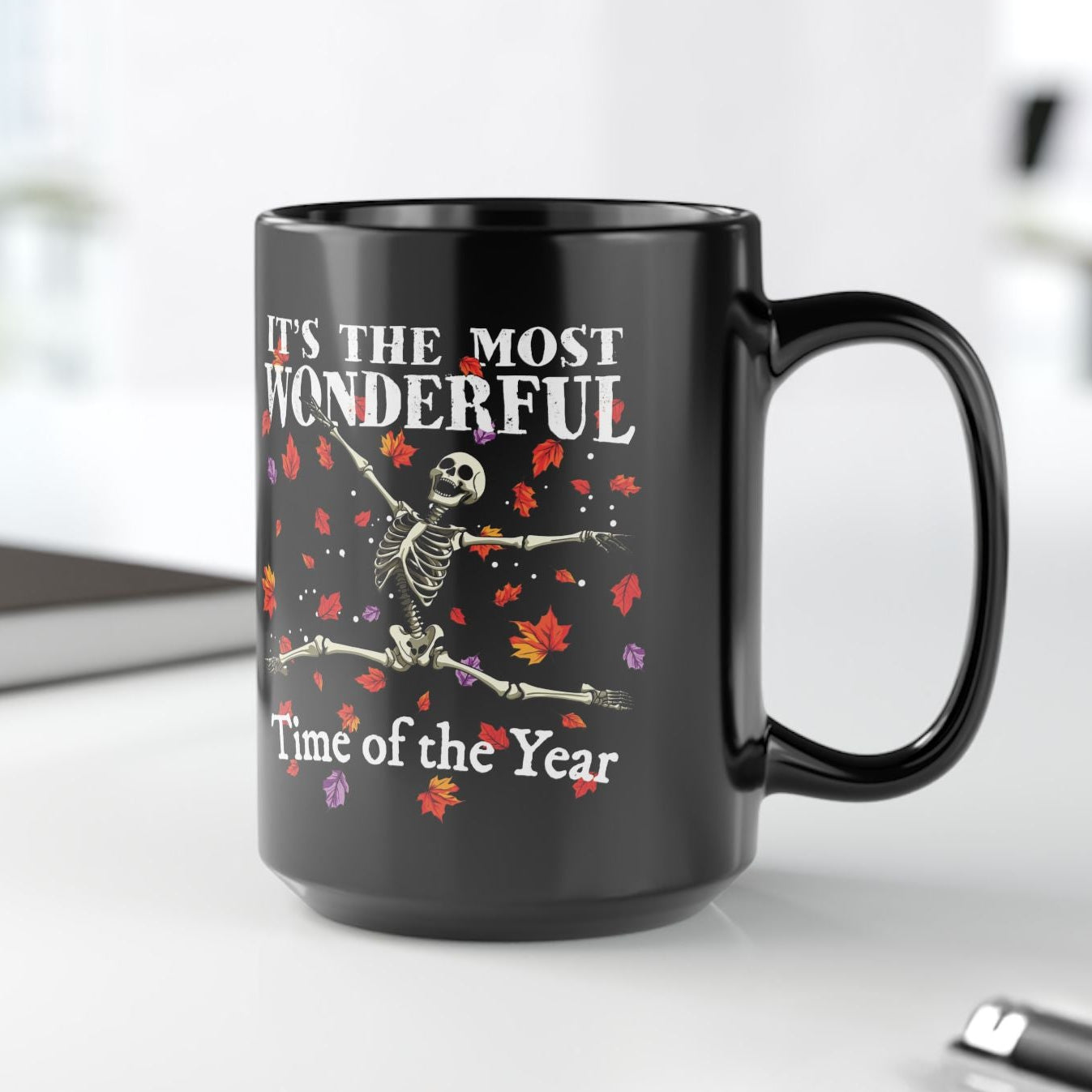 Black mug with skeleton design and text on a white background