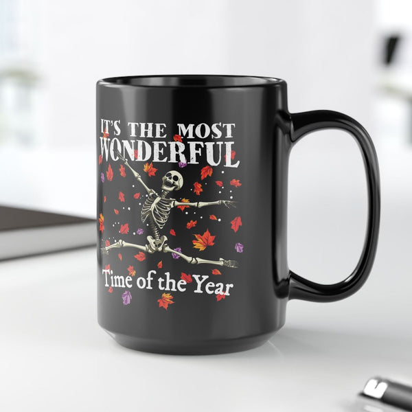 Black mug with skeleton design and text on a white surface