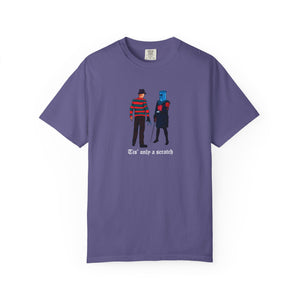 Purple t-shirt with graphic design of two characters and text on a white background