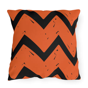 Decorative pillow with orange and black chevron pattern on a white background. Halloween fall indoor outdoor pillow decor.