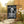 Yard flag and banner with a skeleton holding a martini that says Bone-jour at the top on a black background.