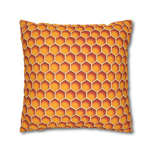 A square-shaped accent pillow with a honeycomb pattern in orange and yellow colors.