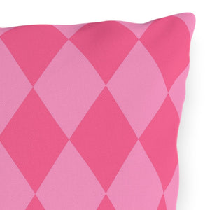 Pink diamond patterned pillow on a white background