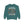 A teal crewneck sweatshirt featuring a Halloween graphic of a dancing skeleton surrounded by colorful autumn leaves, with the text 'IT'S THE MOST WONDERFUL TIME OF THE YEAR'.