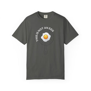 Gray t-shirt with ''This is not an egg' text and an egg in a pan graphic logo on a white background