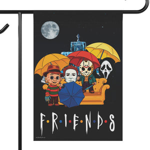 A decorative garden flag on a black metal stand, featuring a black background with the Friends text and illustrated characters from 80's horror movies holding yellow, red, and blue umbrellas under a full moon.