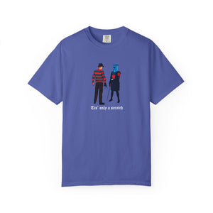 Blue t-shirt with graphic design of two characters and text on a white background