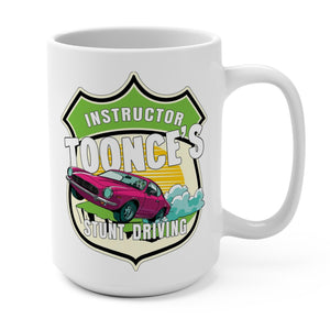A white ceramic mug with a colorful graphic design featuring a pink car and the text 'Instructor Toonce's Stunt Driving'.