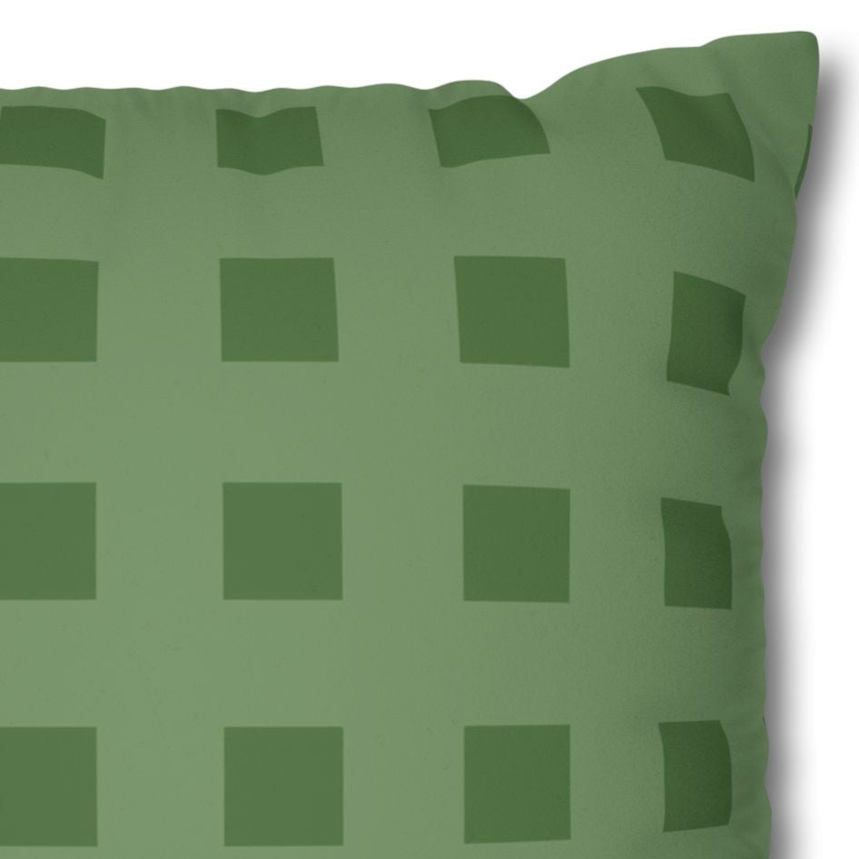 Green checkered pillow on a white background