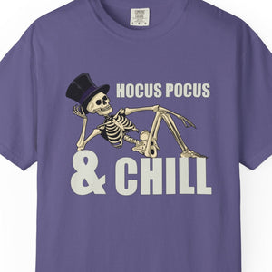 Purple t-shirt with skeleton design and 'HOCUS POCUS & CHILL' text on a white background