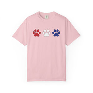 Pink t-shirt with red, white, and blue paw prints on a white background