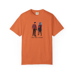Orange t-shirt with graphic design of two characters and text on a white background
