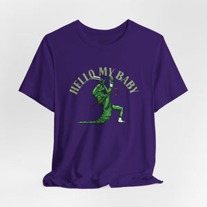 Purple t-shirt short-sleeve crewneck t-shirt featuring a green alien dancing, with the text 'HELLO MY BABY' arched above it, displayed on a light gray background.