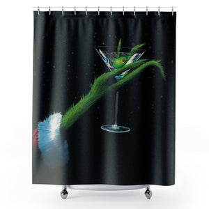 Shower curtain with a grinch hand holding a martini cocktail glass and light snowfall design on a black background