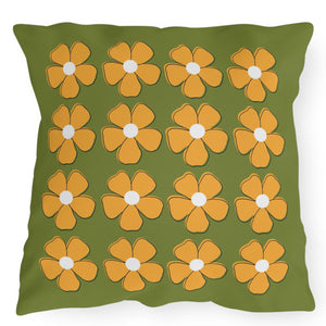 A square-shaped accent pillow with a green background and yellow floral patterns, featuring a concealed zipper.