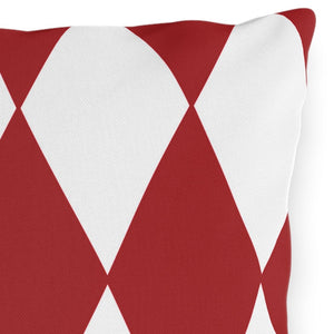 A square-shaped throw pillow with a pattern of red and white diamonds on a white background.