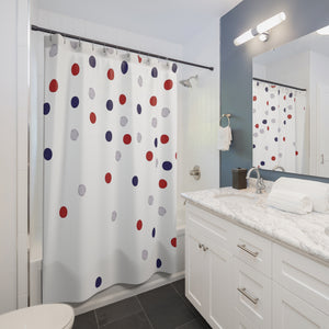 Bathroom with a polka dot shower curtain, white vanity, and mirror.