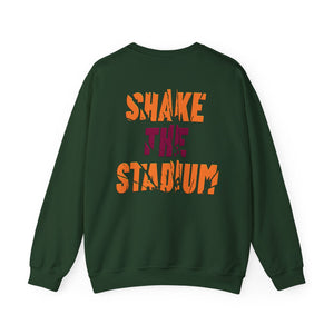 A dark green crewneck sweatshirt shown from the back, featuring the text 'SHAKE THE STADIUM' printed in a distressed orange font, with 'THE' in a contrasting dark purple font.