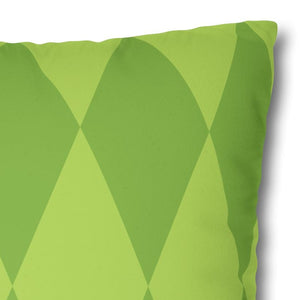 Green pillow with diamond pattern on a white background