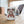 White mug with Santa Claus design and 'Moonshine Distillery' text on a wooden surface.