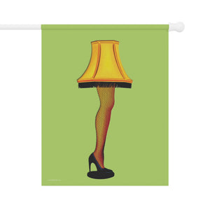 A vertical garden flag featuring a stylized illustration of a lamp shaped like a woman's leg in fishnet stockings and a black high heel, set against a light green background. The flag is shown hanging from a white pole against a plain white backdrop.
