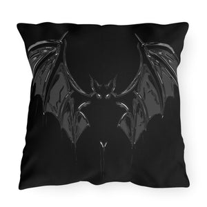 A square outdoor decor pillow with a black bat design.