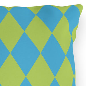 Decorative pillow with blue and green diamond pattern on a white background