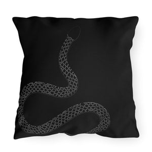 A black outdoor throw pillow with a subtle snakeskin pattern.