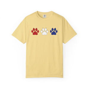 Yellow t-shirt with red, white, and blue paw prints on a white background