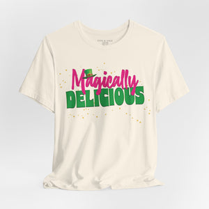 Heather green t-shirt with 'Magically Delicious Funny St. Patrick's Day' design on a white background