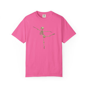 A bright pink short-sleeve crewneck t-shirt featuring a graphic of a dancing skeleton in the center chest, displayed on a clean white background.